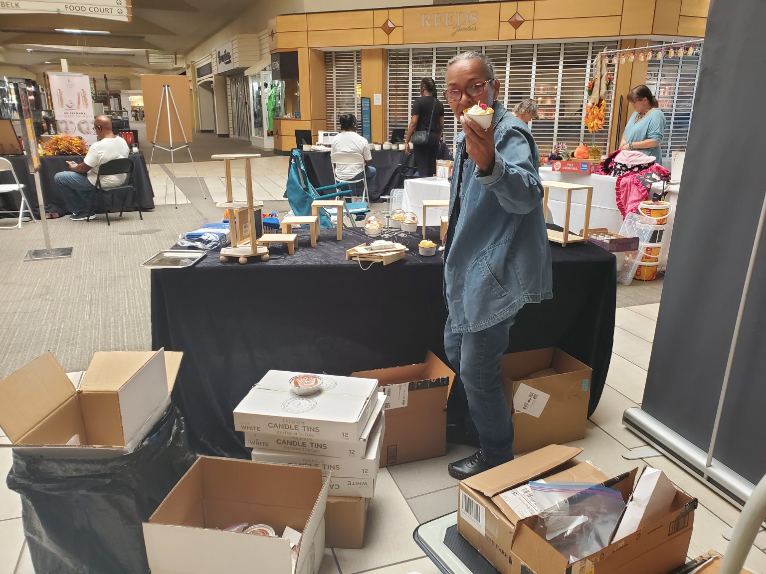 Holding a handcrafted cupcake candle at the Northwoods Mall event