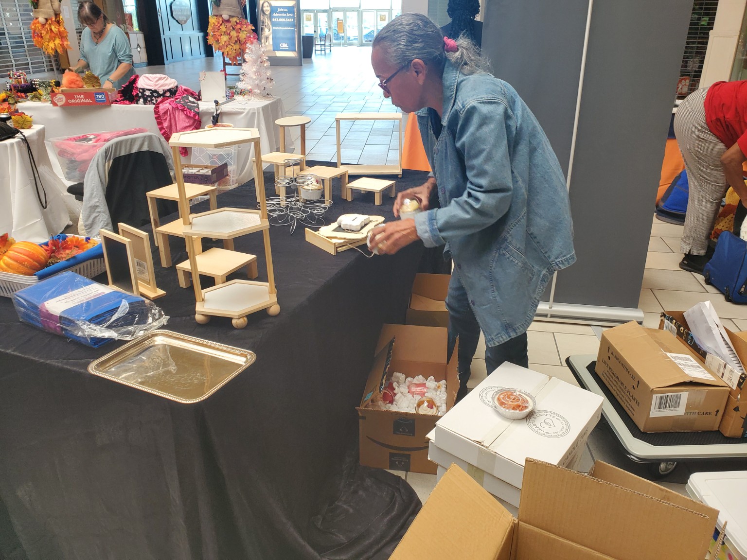 Preparing the Island Candle Company booth at Northwoods Mall