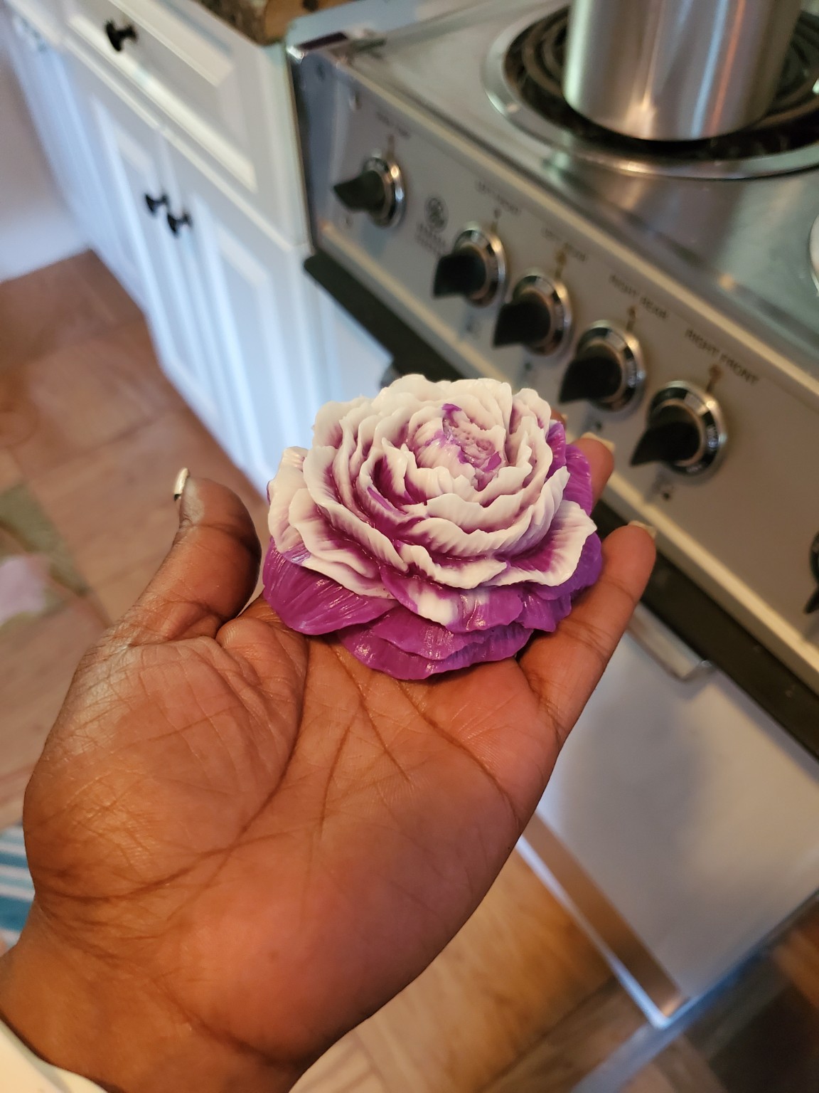 Purple and white wax flower freshly removed from its mold