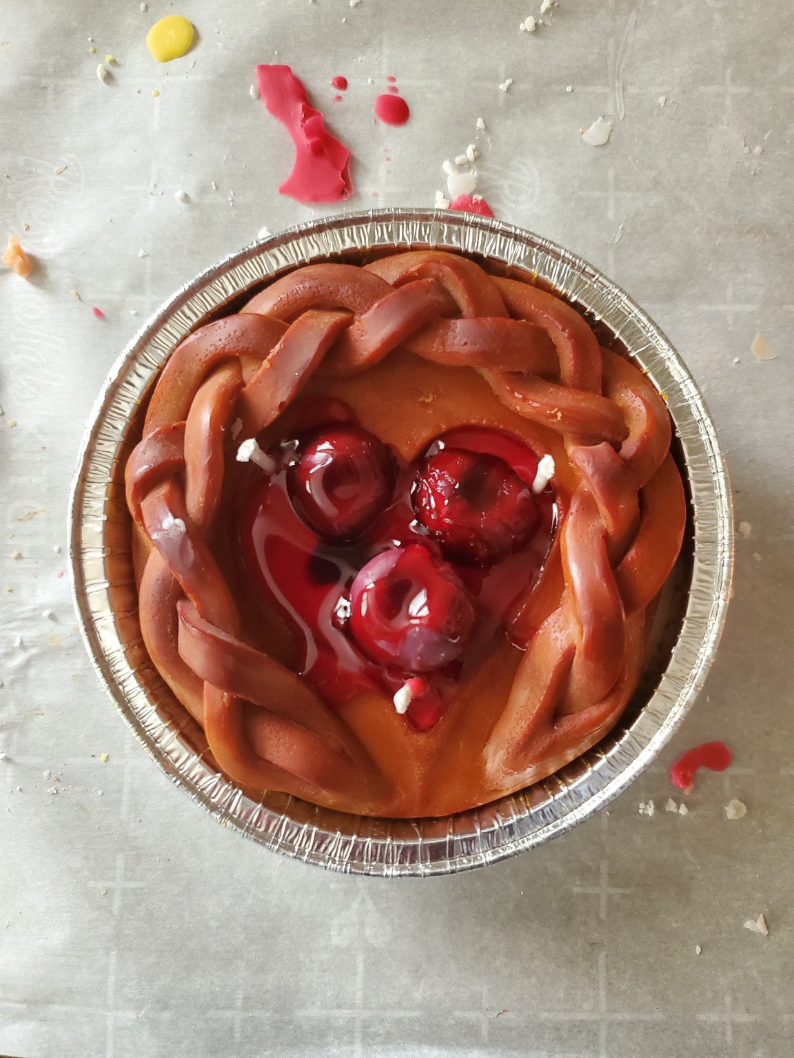 Handcrafted heart-shaped cherry pie candle during assembly